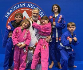 Coach Ryan Kagay training with kids in Brazilian Jiu-Jitsu class at Gracie Barra Argyle in Argyle TX