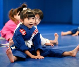 A young student practicing technique during kids' Jiu-Jitsu class. Young girl training in kids' Jiu-Jitsu class at Gracie Barra Argyle in Argyle TX