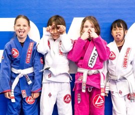 Students having fun together during kids Jiu-Jitsu training at Gracie Barra Argyle. Kids smiling and making funny faces during Jiu-Jitsu class at Gracie Barra Argyle in Argyle TX