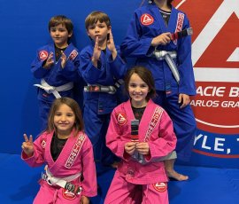 Young students proudly training and earning stripes in kids Jiu-Jitsu classes at Gracie Barra Argyle. Kids in Brazilian Jiu-Jitsu uniforms during class at Gracie Barra Argyle in Argyle TX