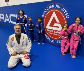 Coach Ryan Kagay leading a fun and structured kids Jiu-Jitsu class at Gracie Barra Argyle, helping students build confidence, discipline, and teamwork. Coach Ryan Kagay training with kids in Brazilian Jiu-Jitsu class at Gracie Barra Argyle in Argyle TX